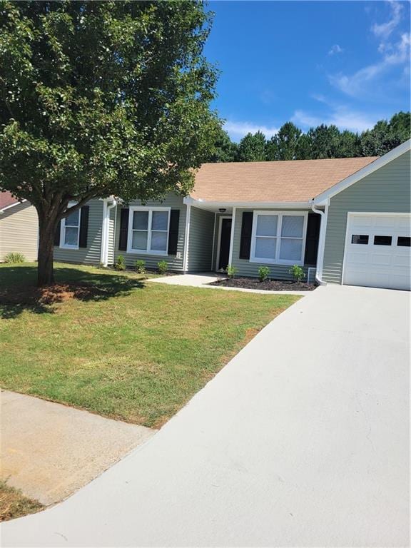 view of front of property with a front lawn and a garage