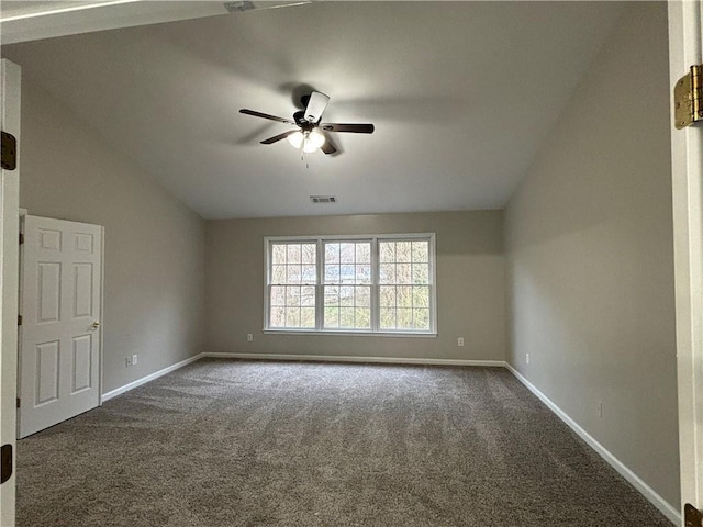 spare room featuring ceiling fan, lofted ceiling, and light carpet