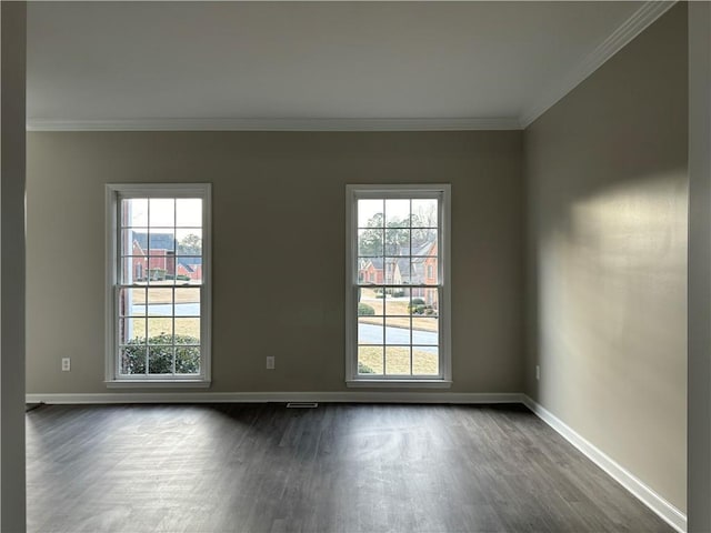 unfurnished dining area featuring dark wood-type flooring, ornamental molding, a raised ceiling, and a notable chandelier