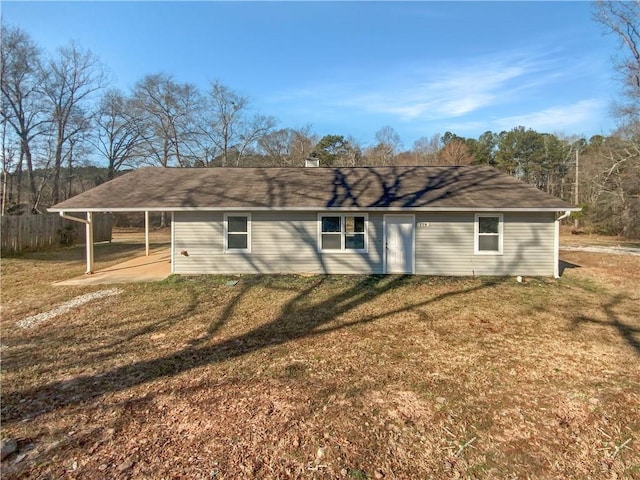 back of house featuring a patio area and a lawn