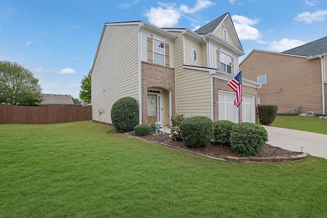 view of front of home with a front yard and a garage