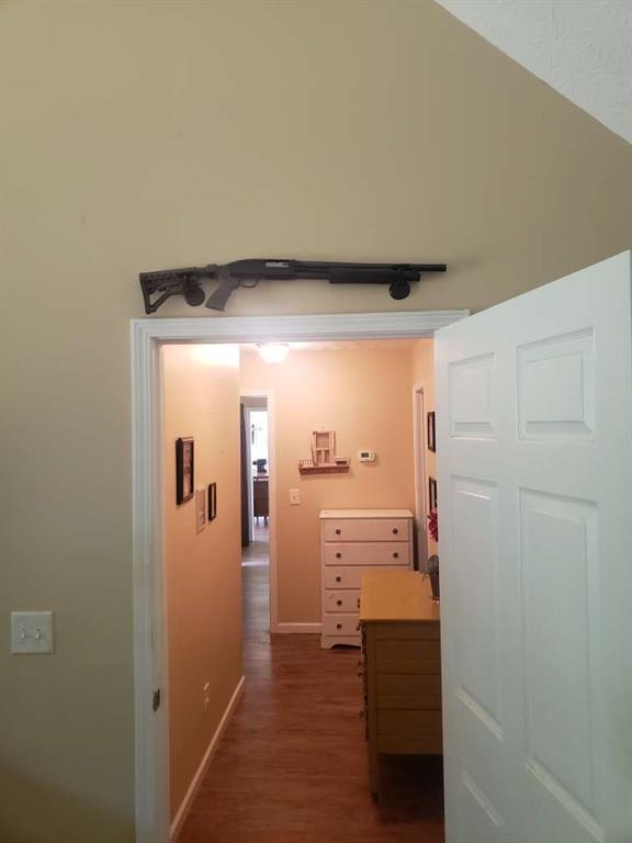 1383 Sims Rd, Winder, GA 30680 - corridor featuring dark wood-type flooring and baseboards