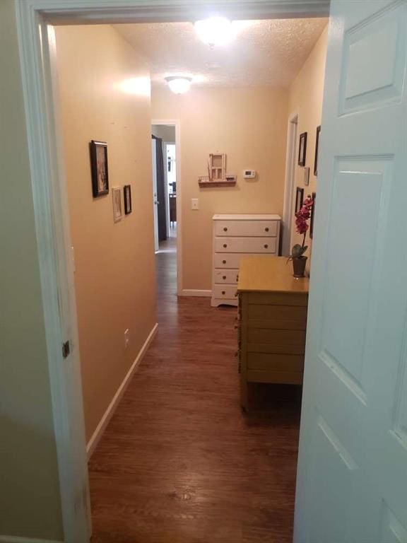1383 Sims Rd, Winder, GA 30680 - corridor with dark wood finished floors, baseboards, and a textured ceiling
