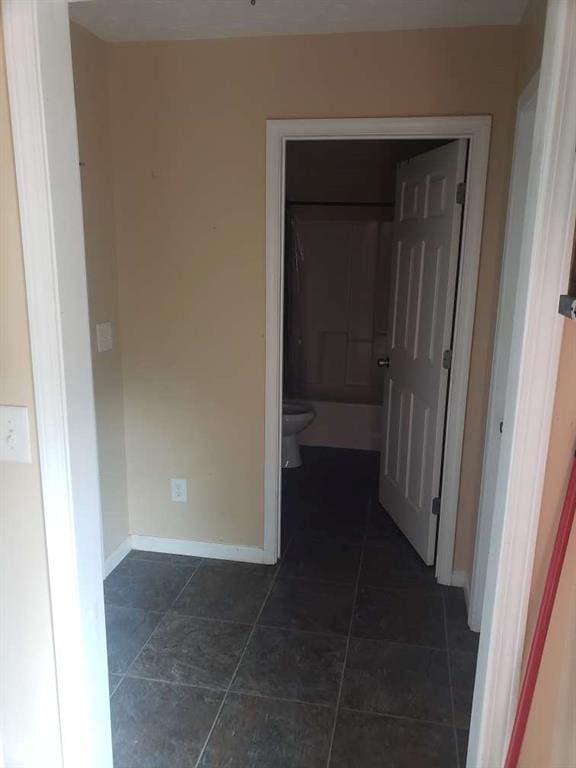 1383 Sims Rd, Winder, GA 30680 - hallway featuring baseboards and dark tile patterned floors