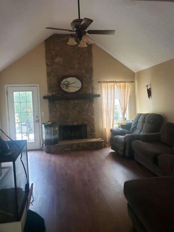 1383 Sims Rd, Winder, GA 30680 - living area featuring vaulted ceiling, ceiling fan, wood finished floors, and a stone fireplace