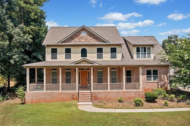 view of front of property featuring a porch and a front lawn