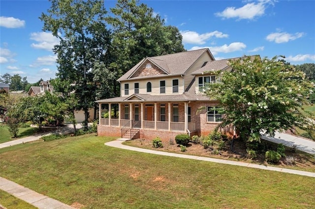 craftsman-style home featuring a porch and a front yard