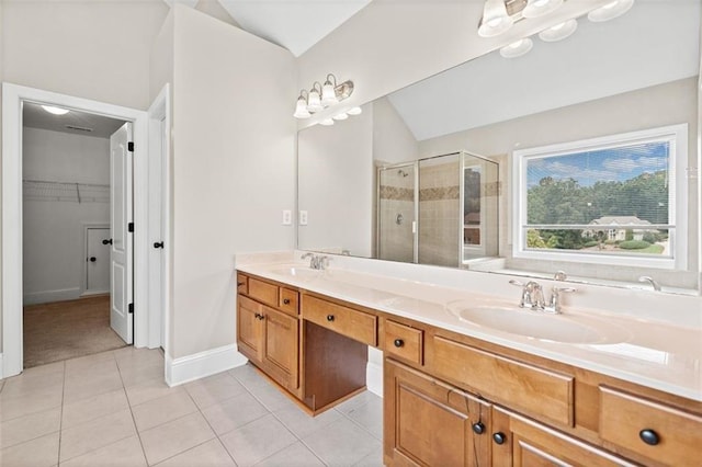 bathroom with lofted ceiling, vanity, tile patterned floors, and an enclosed shower