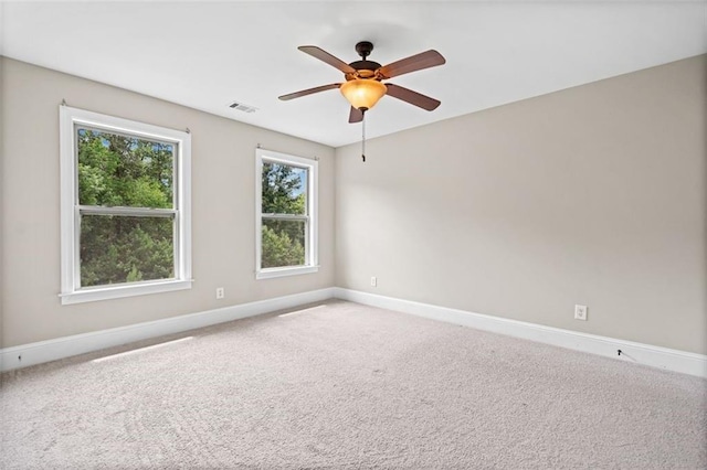 carpeted spare room with ceiling fan