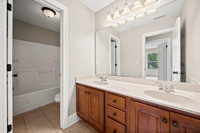 bathroom with vanity, tile patterned flooring, and toilet