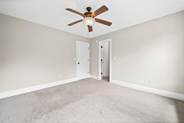 spare room with carpet and ceiling fan