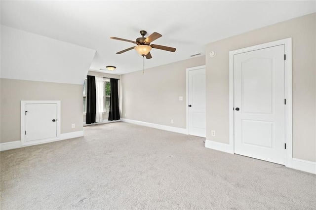 interior space with ceiling fan and light colored carpet