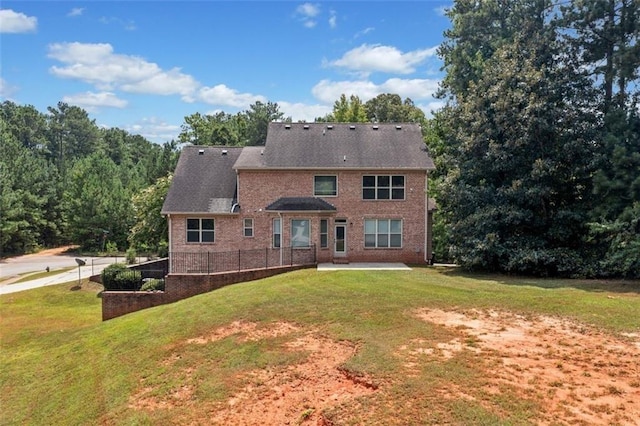 rear view of property with a lawn