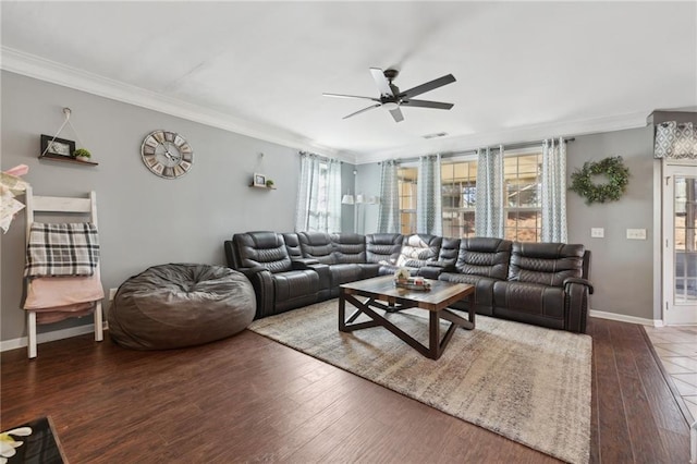 living room with wood finished floors, a ceiling fan, and crown molding