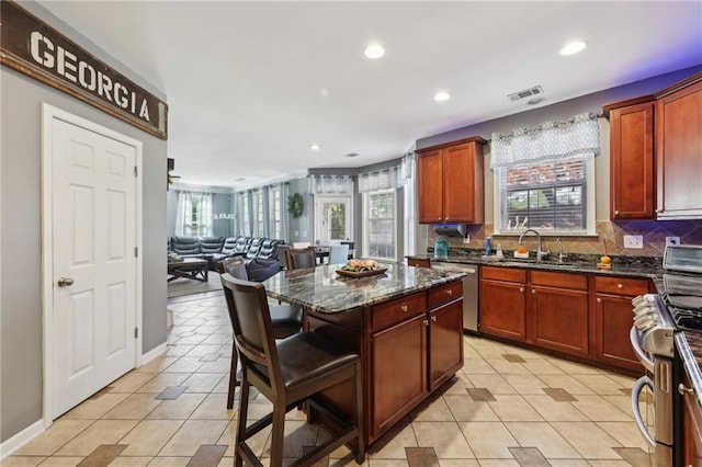 kitchen featuring a wealth of natural light, visible vents, a sink, and light tile patterned floors