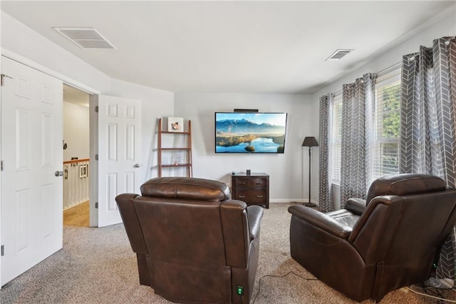 living room with baseboards, visible vents, and light colored carpet