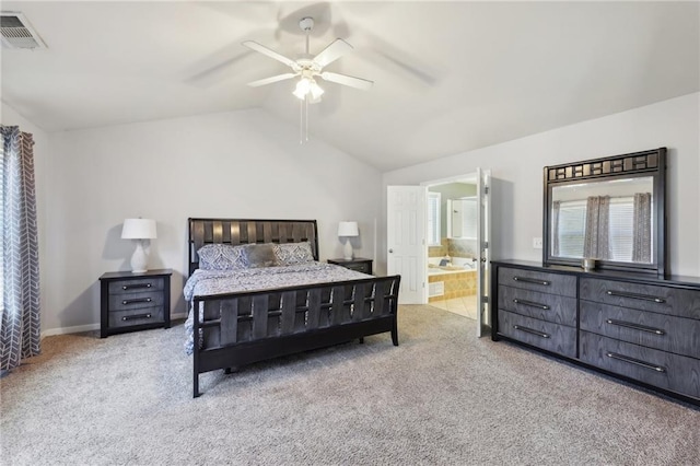 carpeted bedroom with lofted ceiling, visible vents, ensuite bathroom, a ceiling fan, and baseboards