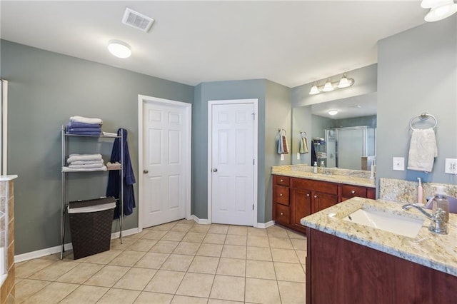 bathroom with two vanities, a sink, visible vents, a shower stall, and tile patterned floors