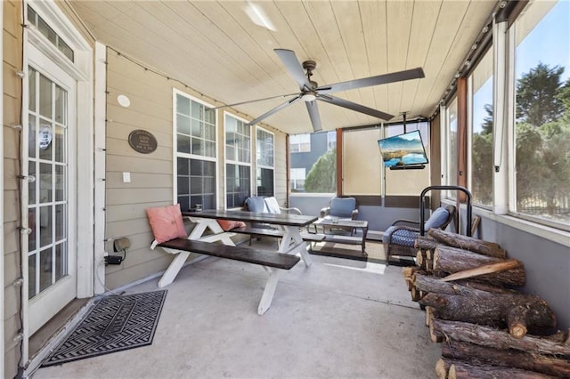 sunroom featuring wooden ceiling and ceiling fan