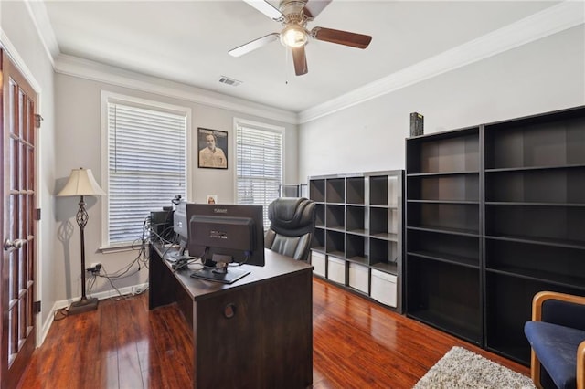 office space featuring ceiling fan, dark wood-type flooring, visible vents, baseboards, and crown molding