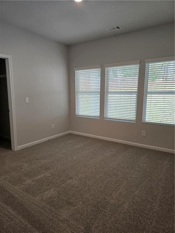 empty room featuring dark colored carpet