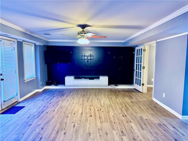 unfurnished living room featuring wood-type flooring, ceiling fan, and ornamental molding