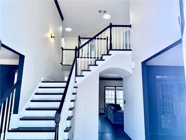 stairway featuring ornamental molding