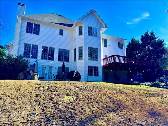 back of property featuring french doors and a deck