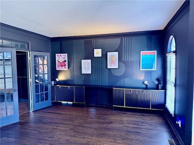 interior space featuring french doors, dark wood-type flooring, and crown molding