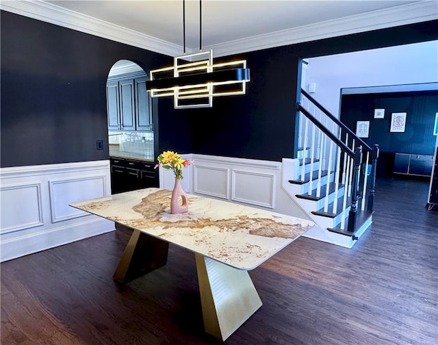 dining room with dark hardwood / wood-style flooring and ornamental molding