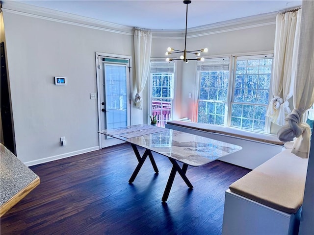 dining area with dark hardwood / wood-style flooring, ornamental molding, and a chandelier