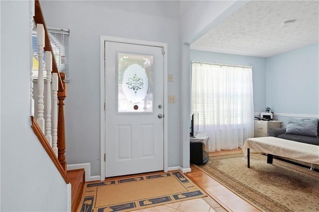 entrance foyer featuring a textured ceiling