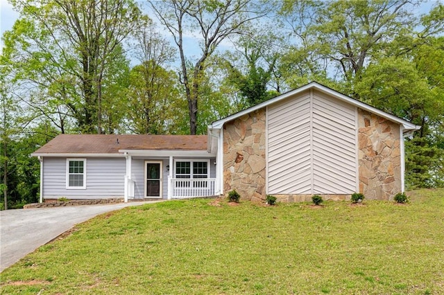 view of front facade featuring a front yard and stone siding