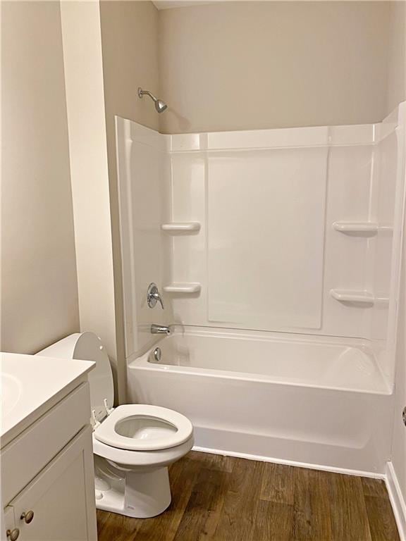 full bath featuring vanity, toilet, wood finished floors, and bathtub / shower combination