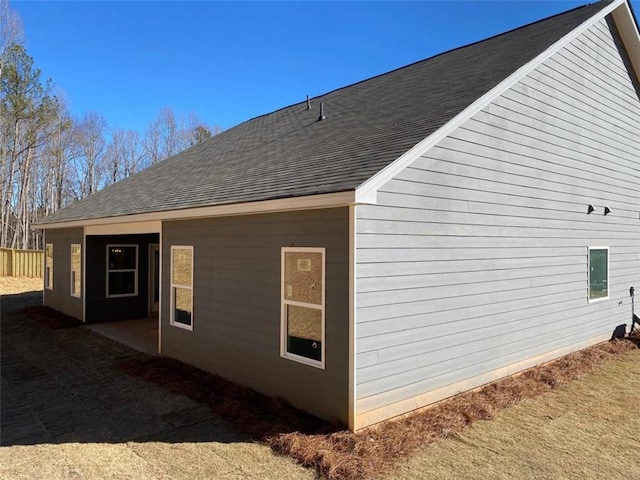 view of side of home featuring a shingled roof
