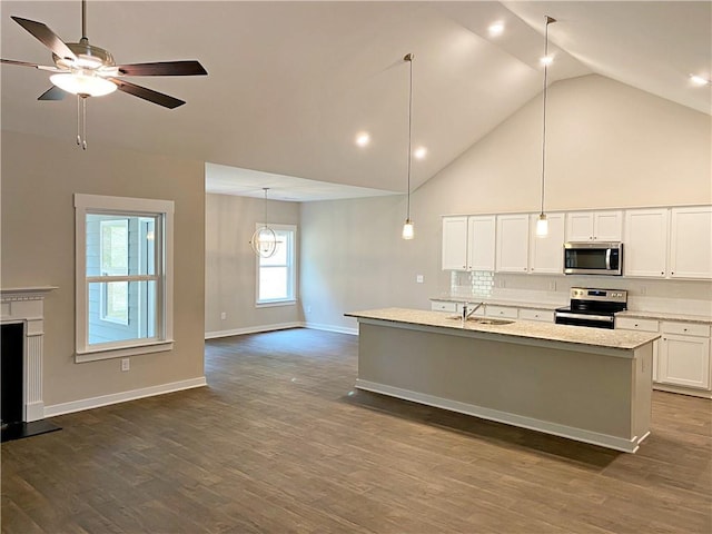 kitchen with decorative backsplash, a ceiling fan, a sink, white cabinets, and stainless steel appliances