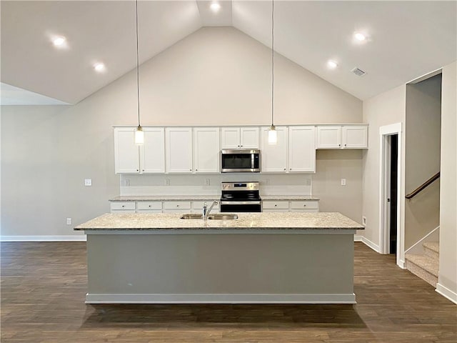 kitchen featuring baseboards, high vaulted ceiling, white cabinetry, a sink, and appliances with stainless steel finishes