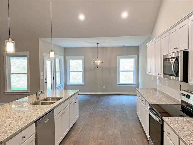 kitchen featuring white cabinets, stainless steel appliances, a sink, and dark wood-type flooring