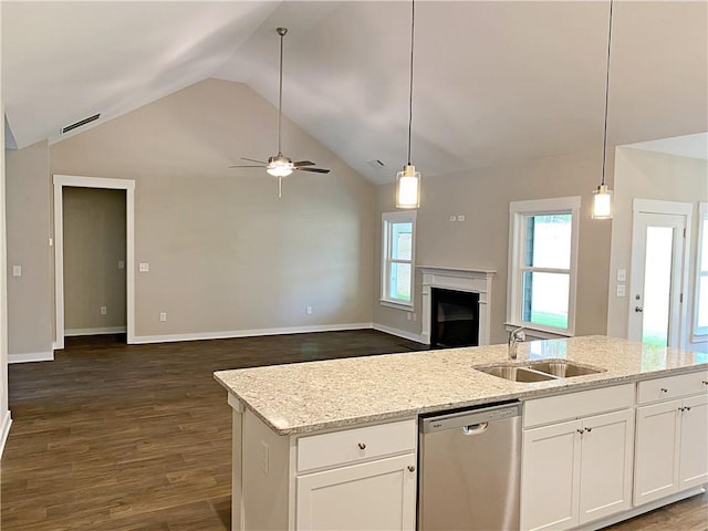 kitchen featuring ceiling fan, stainless steel dishwasher, vaulted ceiling, a sink, and open floor plan