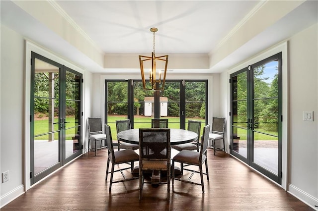 4823 Layfield Dr, Dunwoody, GA 30338 - dining room featuring french doors, a chandelier, dark wood-style floors, crown molding, and a raised ceiling
