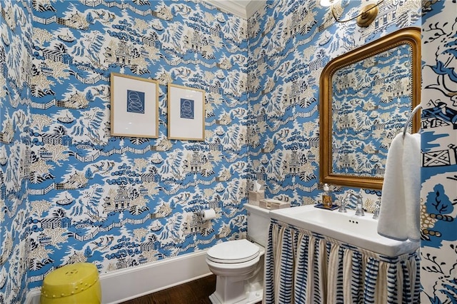 4823 Layfield Dr, Dunwoody, GA 30338 - bathroom featuring wallpapered walls, wood finished floors, toilet, baseboards, and crown molding