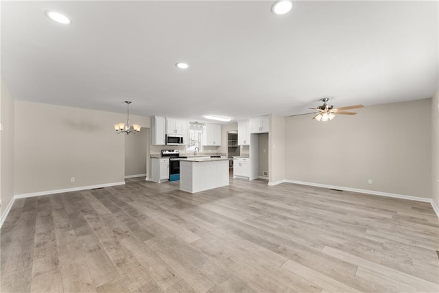 1292 Fernside Dr, Toccoa, GA 30577 - unfurnished living room with a chandelier, baseboards, light wood-style flooring, and recessed lighting