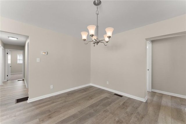 1292 Fernside Dr, Toccoa, GA 30577 - spare room with wood finished floors, baseboards, and a chandelier