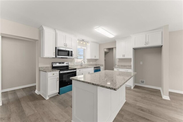 1292 Fernside Dr, Toccoa, GA 30577 - kitchen with range with electric stovetop, a sink, dishwasher, white cabinetry, and light wood-type flooring