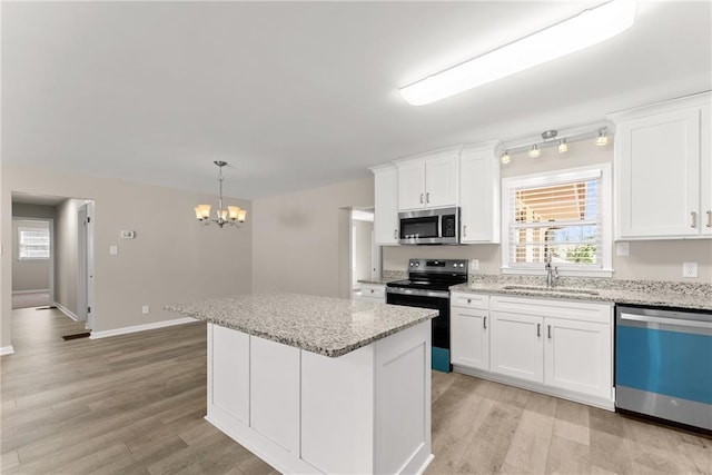 1292 Fernside Dr, Toccoa, GA 30577 - kitchen featuring stainless steel appliances, a sink, a chandelier, light wood-style floors, and a center island