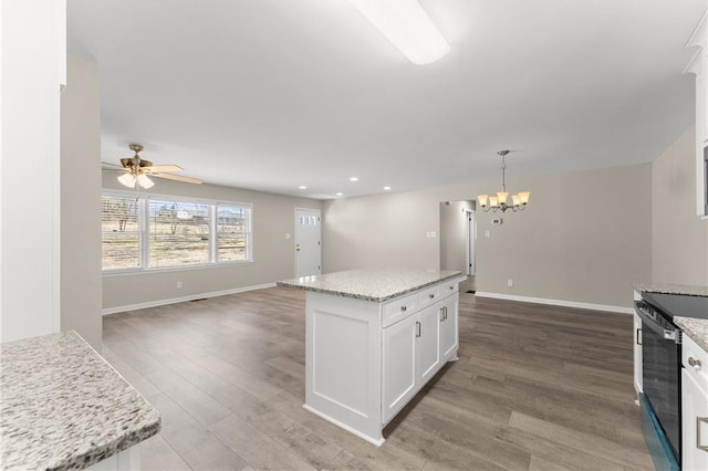 1292 Fernside Dr, Toccoa, GA 30577 - kitchen featuring wood finished floors, white cabinetry, a chandelier, open floor plan, and a center island