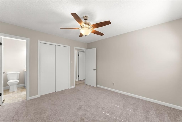 1292 Fernside Dr, Toccoa, GA 30577 - unfurnished bedroom with light colored carpet, a closet, connected bathroom, baseboards, and a ceiling fan