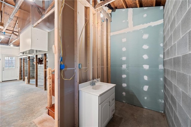 1292 Fernside Dr, Toccoa, GA 30577 - bathroom featuring concrete block wall, vanity, and unfinished concrete flooring