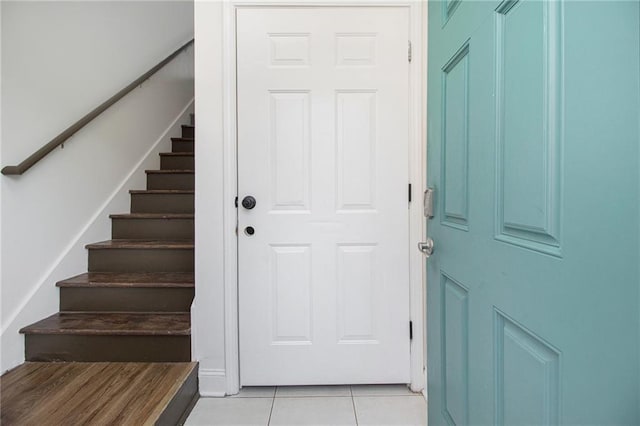 entryway featuring stairs and light tile patterned floors
