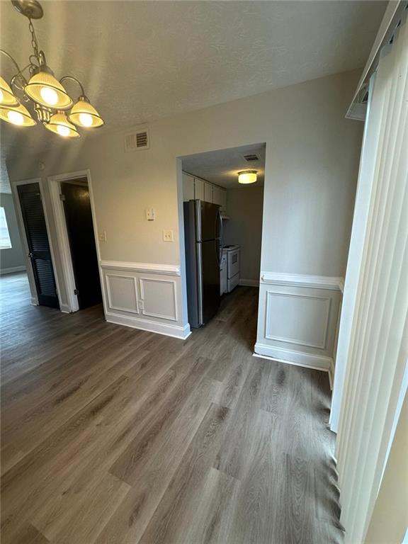 interior space featuring wood-type flooring and a notable chandelier